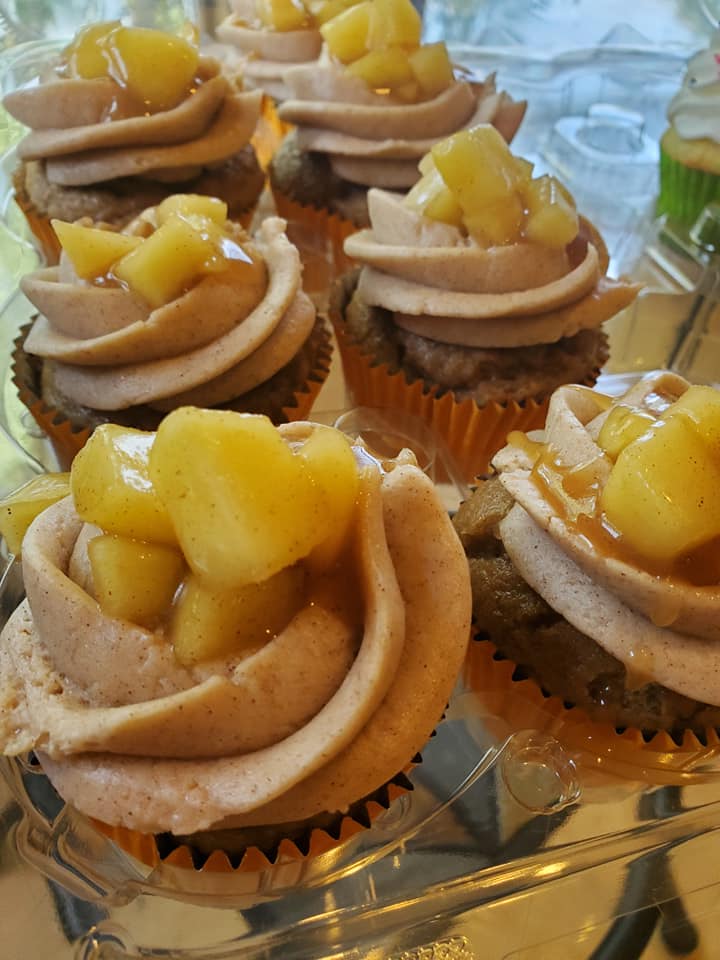 Peanut Butter Cupcakes with chocolate frosting on dark chocolate cupcake.  Reese's peanut butter cup topping.. 