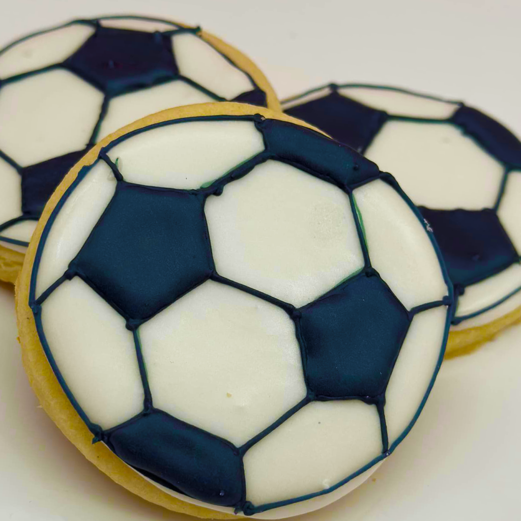 Soccer ball on Almond cookie.  Sugar cookie in the shape of a Soccer ball.