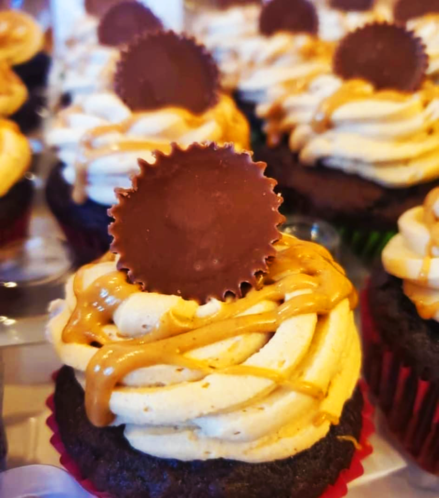 Reese's Peanut butter cup top peanut butter cupcake.  Chocolate frosting with Peanut butter on Chocolate cake. 