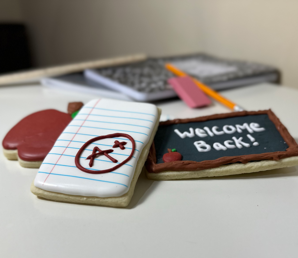 Cookies - Apple, chalkboard, A plus paper cookie. School items in back grond.