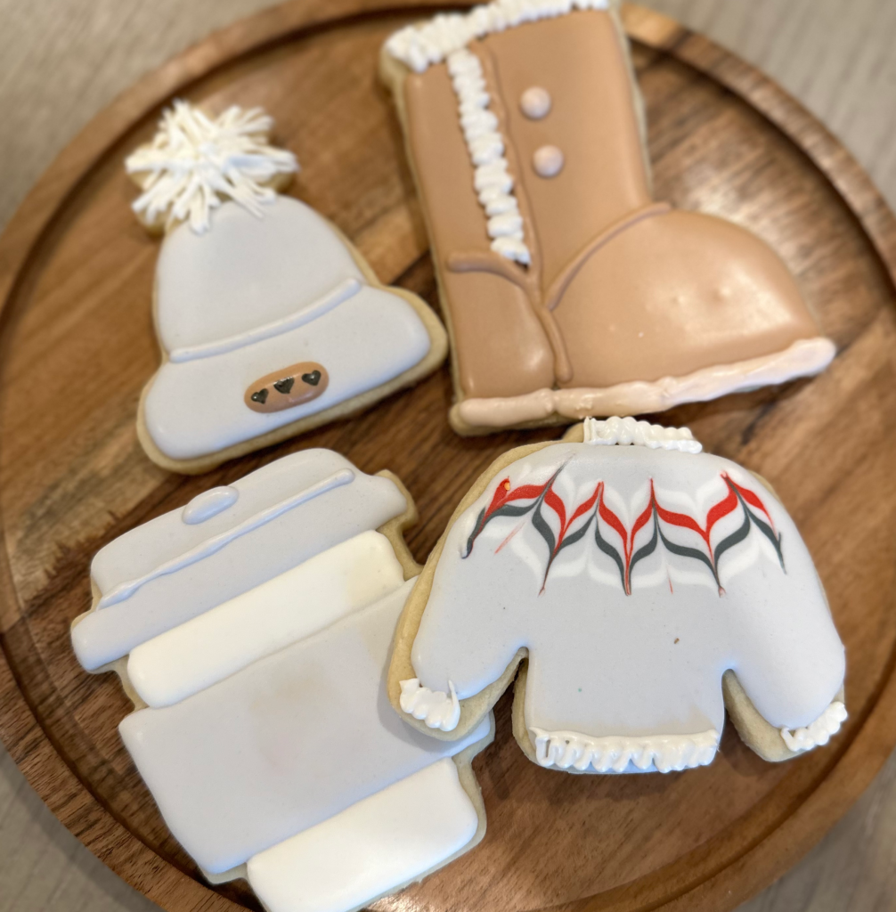 Winter boot cookie, sweater, stocking cap and coffee cup.